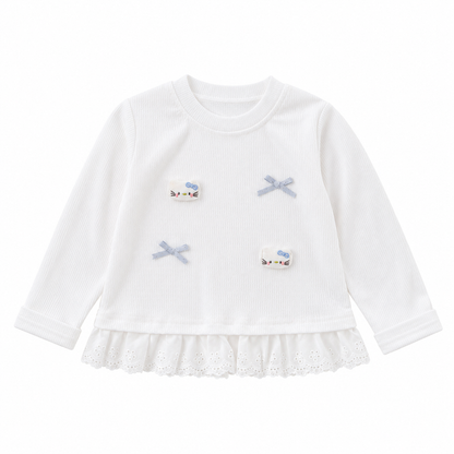 Front flat lay of a white girls cotton ruffle top with long sleeves and bow applique details on a white background.