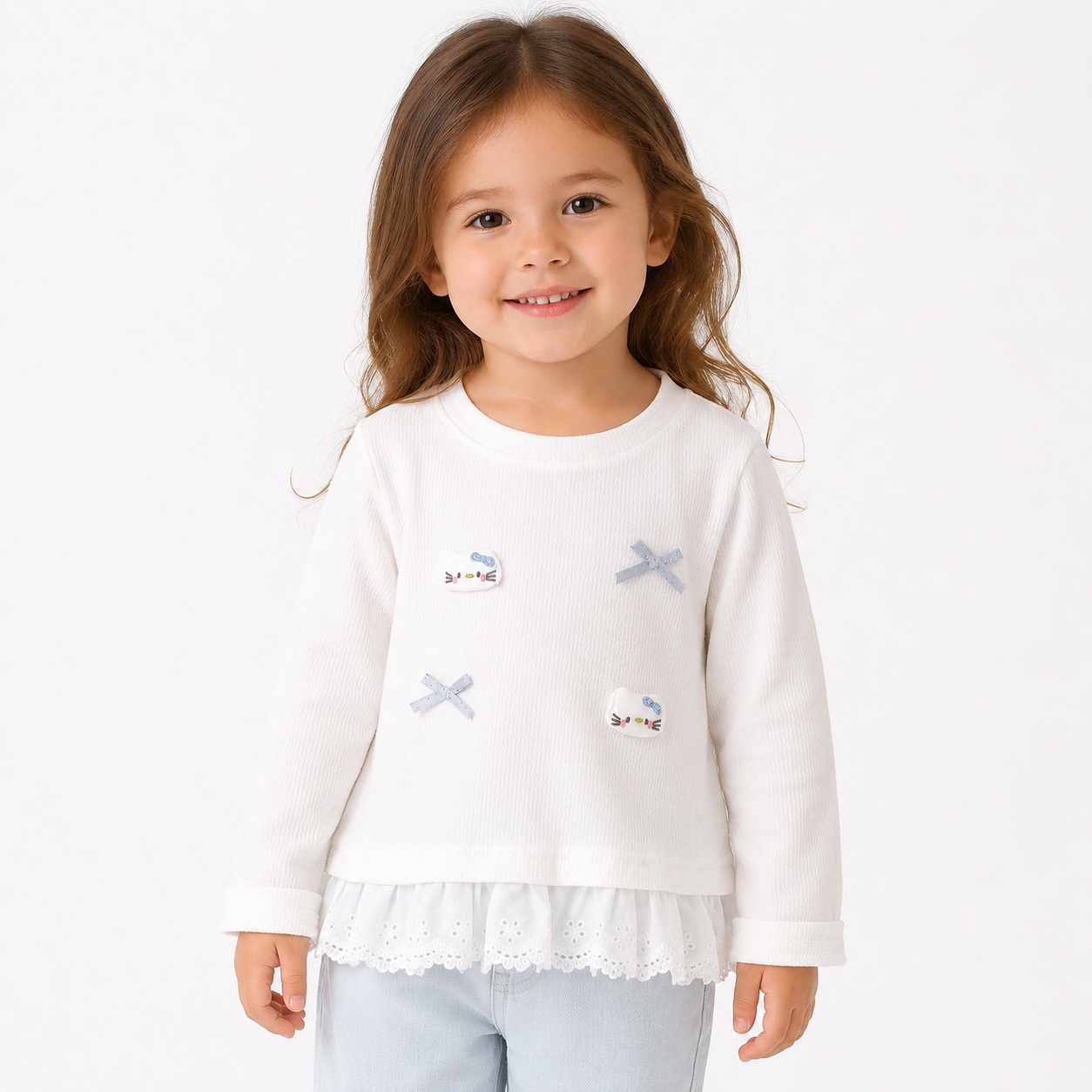 Girl model wearing a white long sleeve cotton ruffle top on a white studio background.