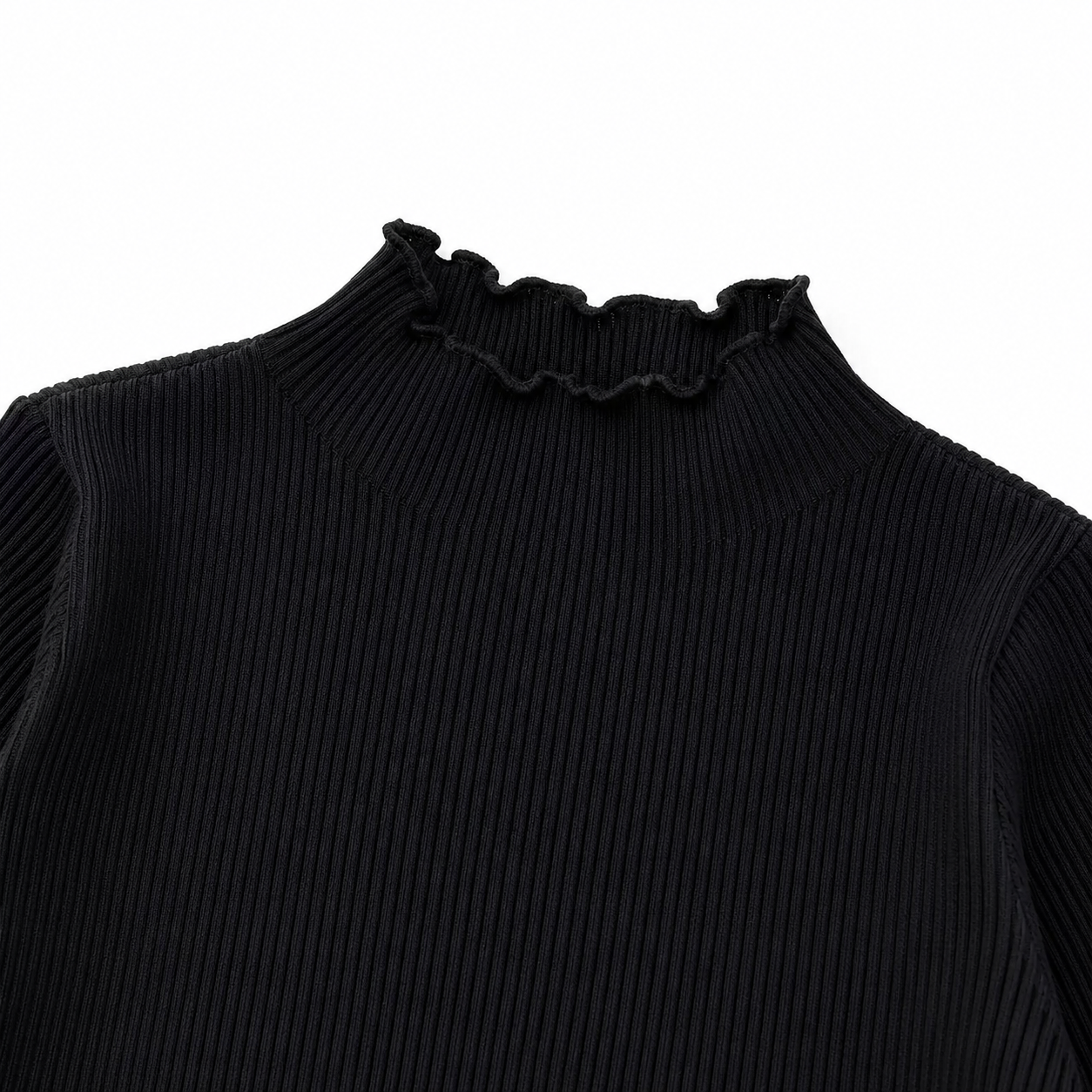Close-up of the black ruffle-edge neckline and vertical ribbed texture.
