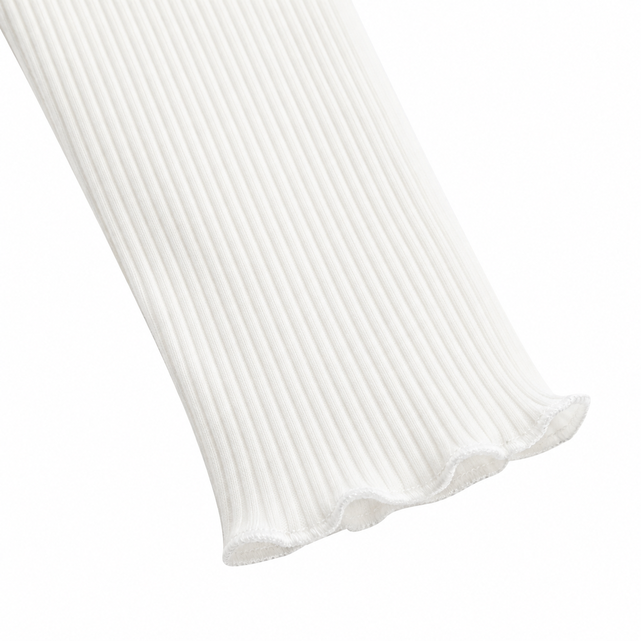Close-up of the ivory long sleeve cuff with lettuce-edge finish.