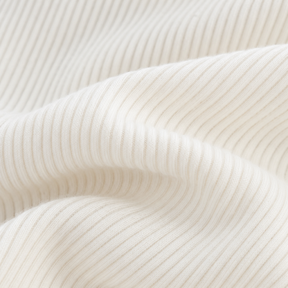 Close-up of the ivory ribbed fabric texture and finished edge.