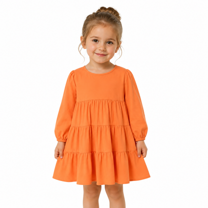 Girl model wearing the orange cotton tiered dress for everyday wear.