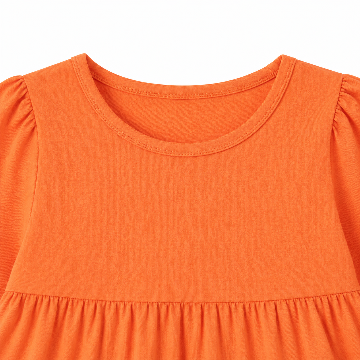Close-up of the round neckline and gathered shoulder detail on the orange girls dress.