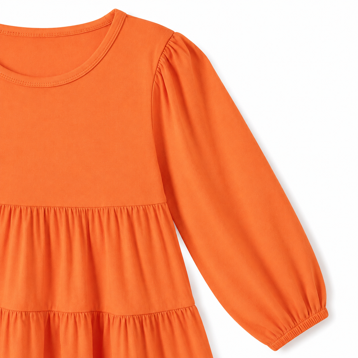Close-up of the long sleeve and elastic cuff on the orange cotton dress.