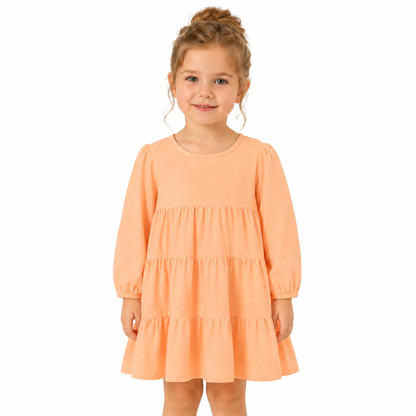 Girl model wearing the peach cotton tiered dress for everyday wear.