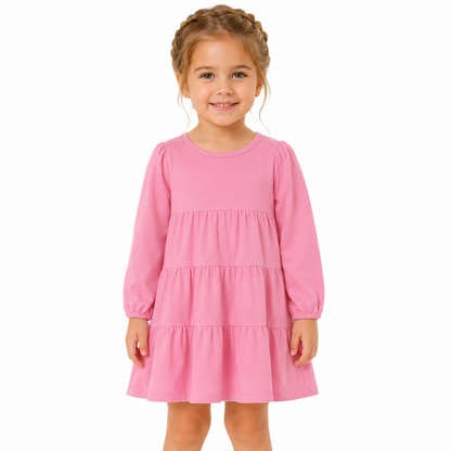 Girl model wearing the pink cotton tiered dress for everyday wear.