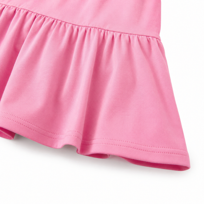 Close-up of the elastic cuff and cotton fabric texture on the pink long sleeve dress.
