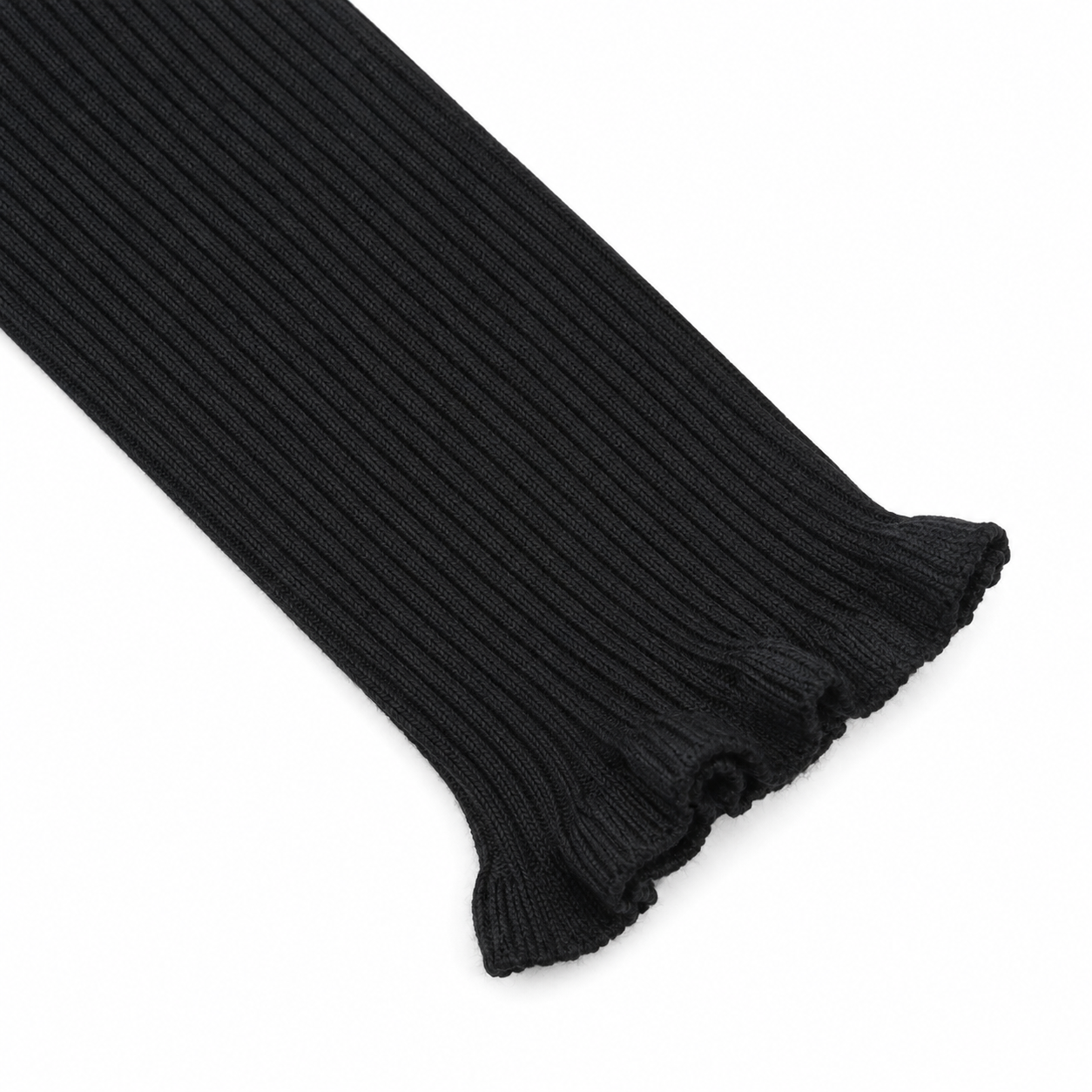 Close-up of the ruffle cuff sleeve detail on the black ribbed long sleeve top.