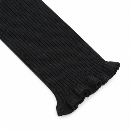 Close-up of the ruffle cuff sleeve detail on the black ribbed long sleeve top.