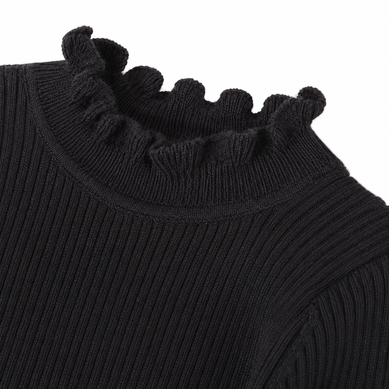 Close-up of the ruffle hem and ribbed texture on the black girls top.