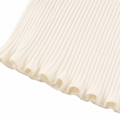 Close-up of the ruffle hem and ribbed texture on the ivory girls top.