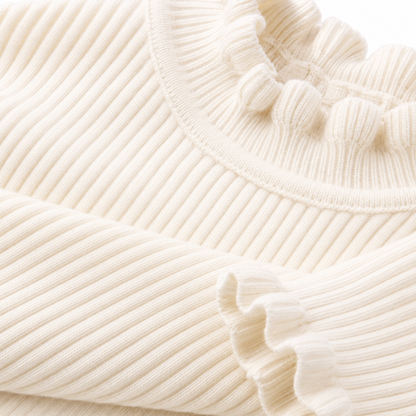 Close-up of the ribbed fabric texture on the ivory long sleeve girls top.