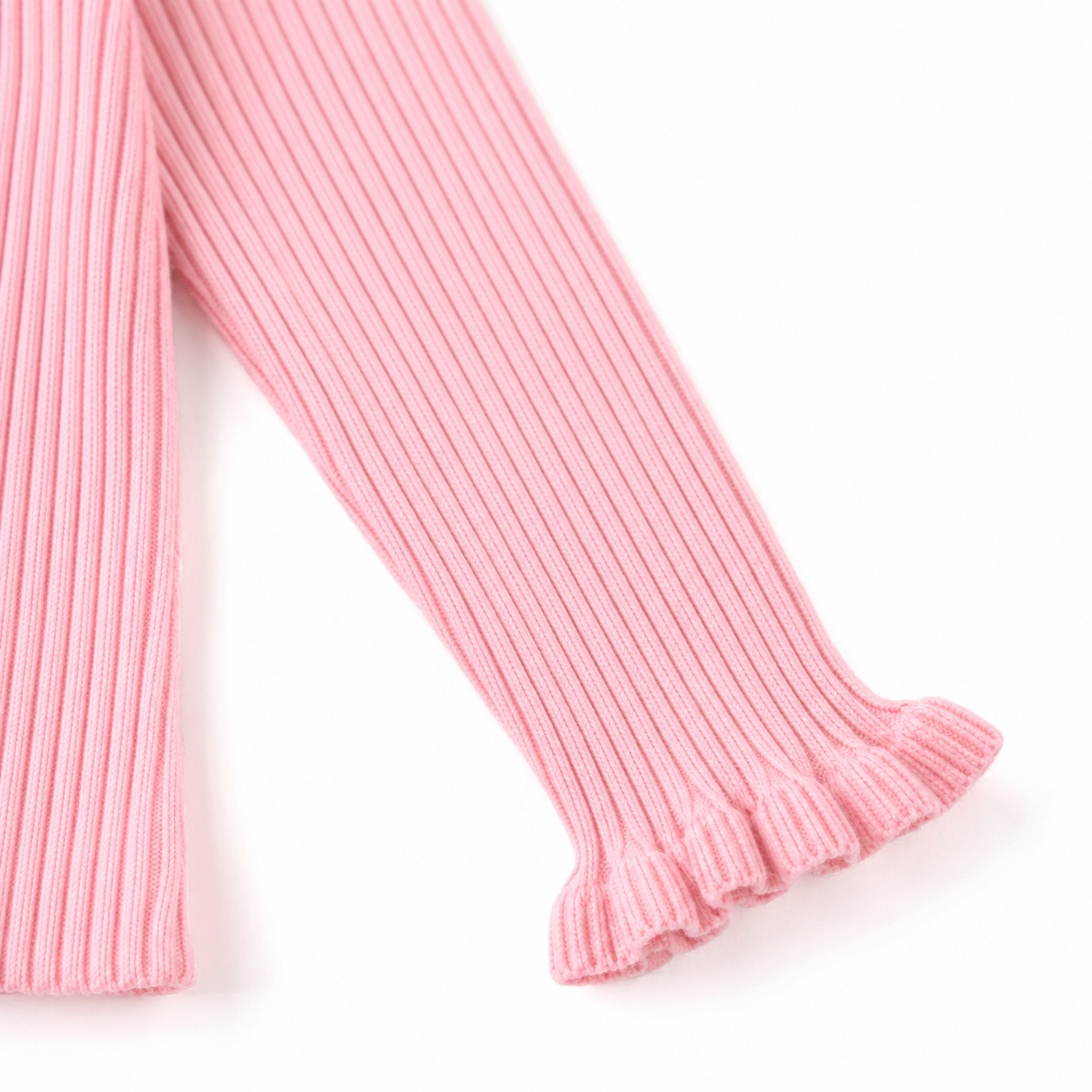Close-up of the ruffle cuff sleeve detail on the pink ribbed long sleeve top.