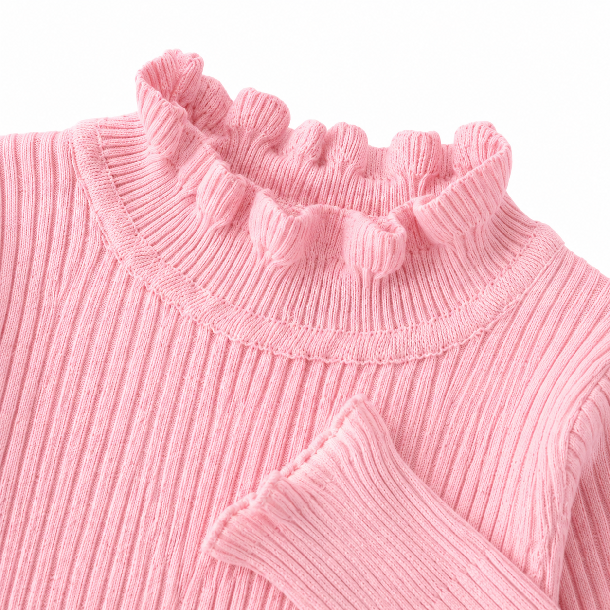 Close-up of the ruffle hem and ribbed texture on the pink girls top.