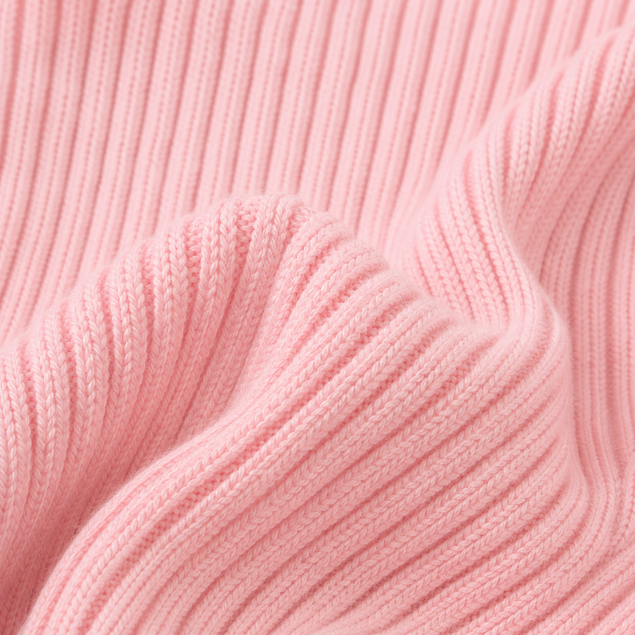 Close-up of the ribbed fabric texture on the pink long sleeve girls top.
