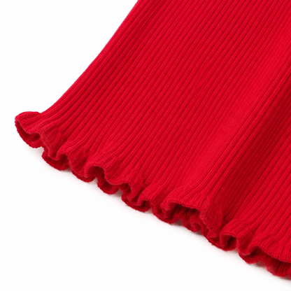 Close-up of the ruffle hem and ribbed texture on the red girls top.